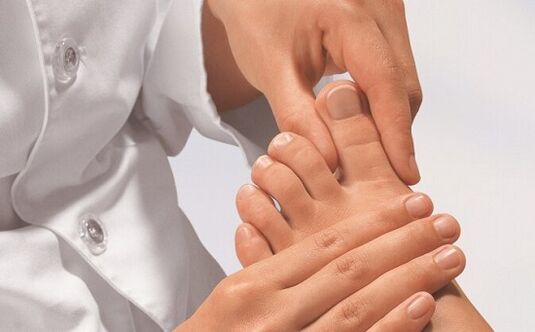 Specialist examines feet for fungal infection